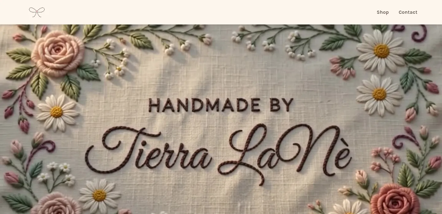 Embroidered flowers on linen stitching into the words Handmade by Tierra LaNè, from the site's scroll-animated hero video.